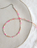 Light pink and beige thin strand necklace with adjustable length on Zara Home plate